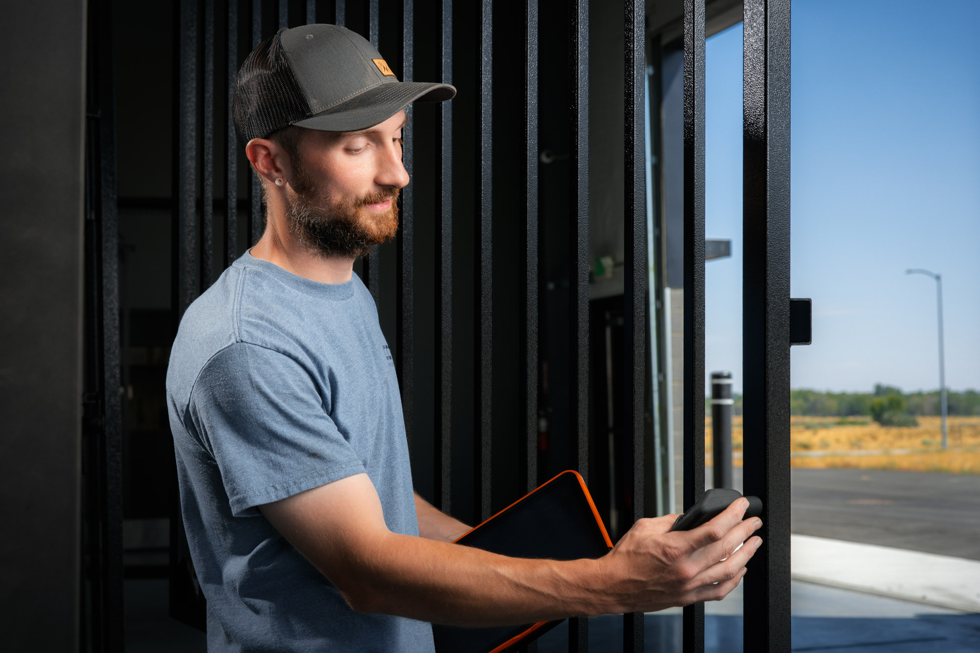 Man operating electronic gate with remote control.