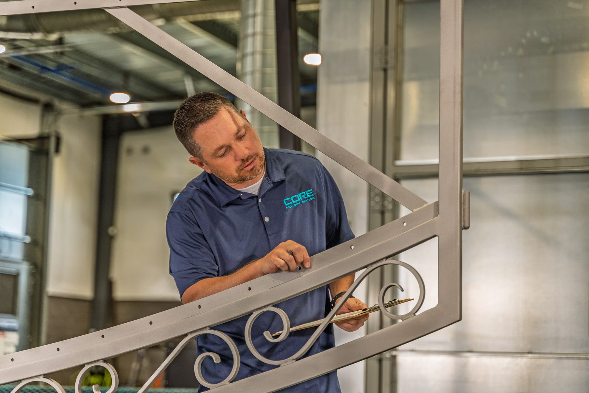 Technician inspecting metal railing in workshop